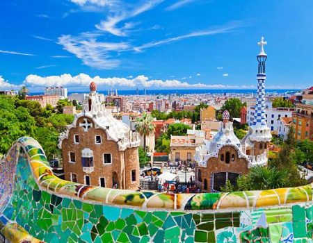 Parc Guell, Barcelona, Spain. Main entrance to Gaudi's Parc Guell and skyline of Barcelona.
