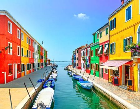 Venice landmark, Burano island canal, colorful houses and boats, Italy. Long exposure photography